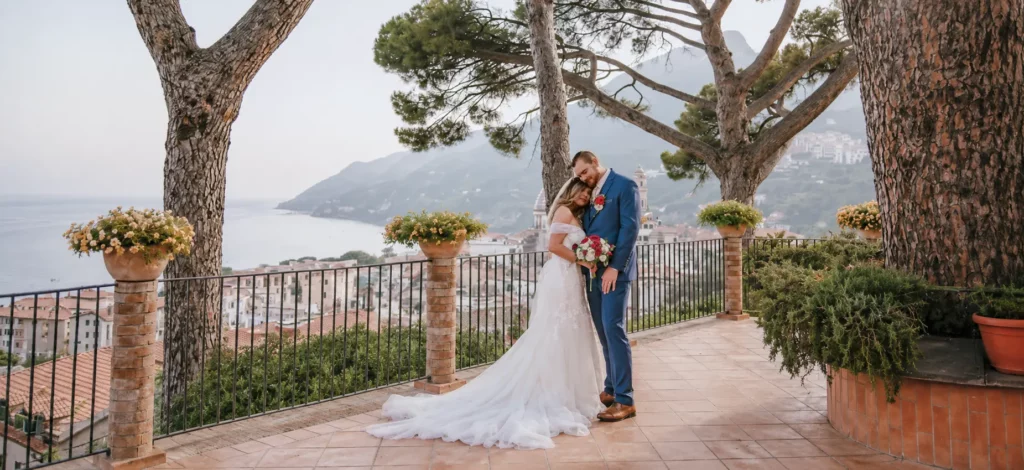Bride and groom embracing on a scenic Amalfi Coast terrace during an Italy elopement with sea and mountain views