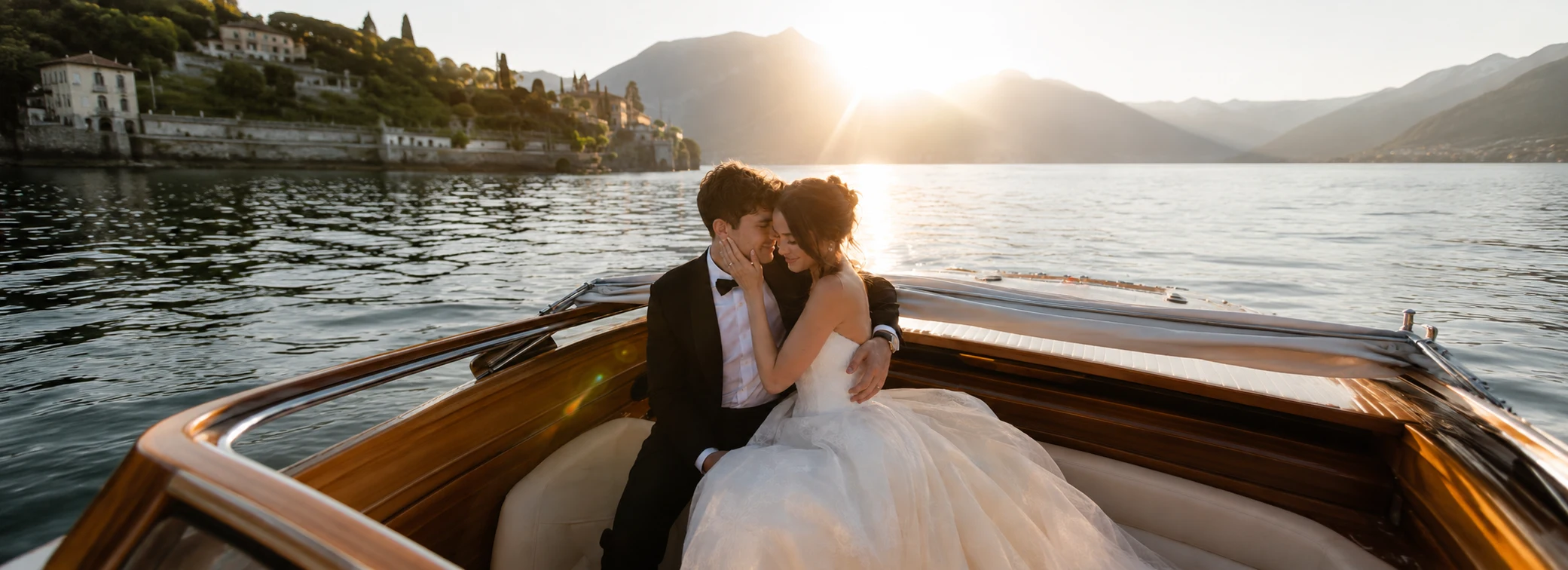 Couple embracing on a wooden boat during an Amalfi Coast elopement at sunset