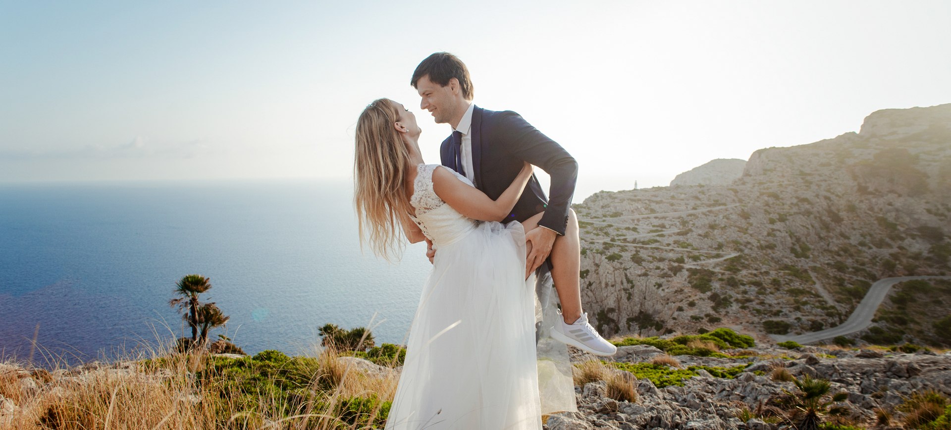 Mallorca beach elopement in Formentor - bride and groom on cliffs during their wedding day