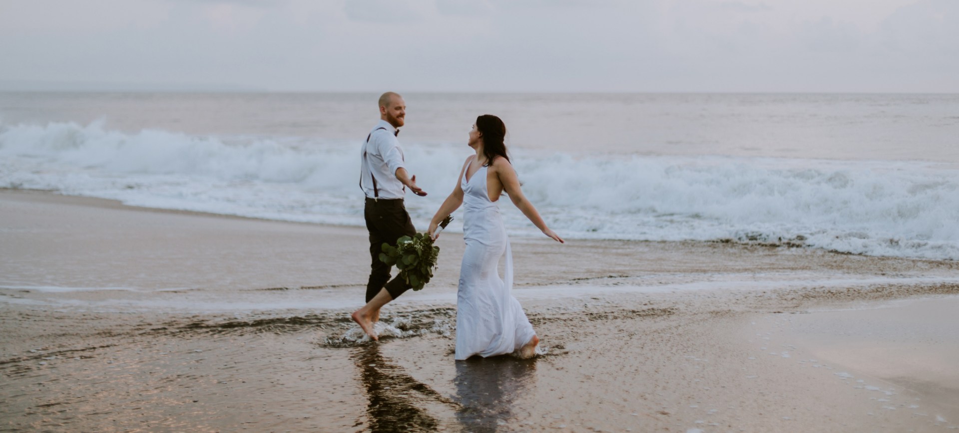bali beach wedding - bride & groom dancing in the water